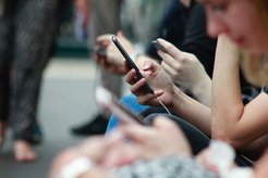 One hand holding a cell phone