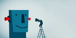 Man on ladder with megaphone speaks to large smiling face with earplugs.