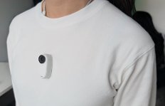 Person in white t-shirt with white camera on it
